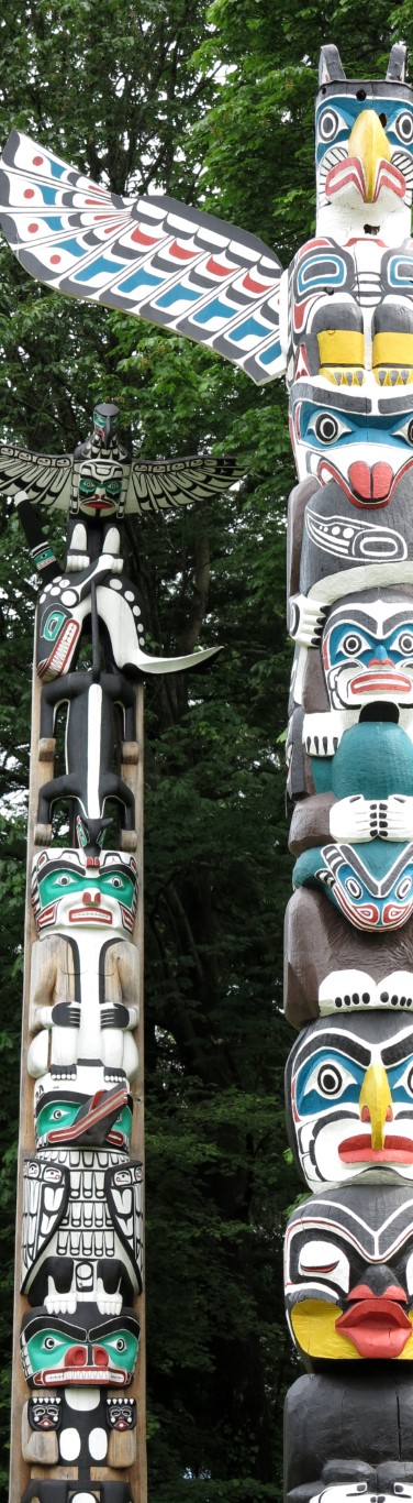 two Indian totems in blue, white and black colors with human and animal faces